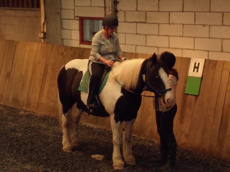 Kym riding Teddy in the arena